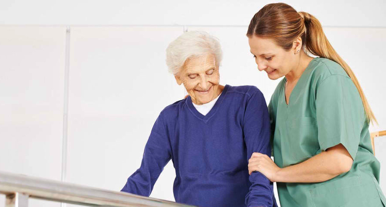 Therapist assisting an older woman with mobility