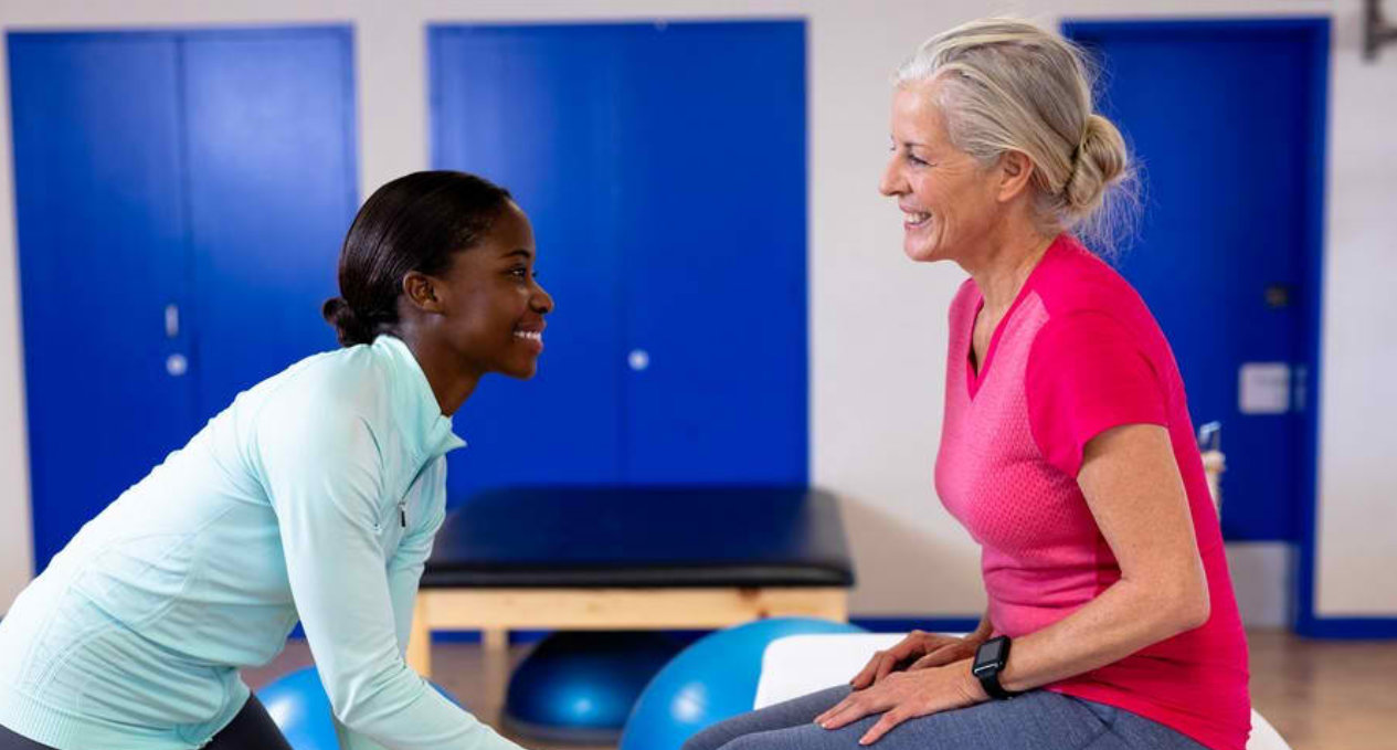 Therapist assisting an older patient